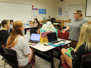 Students seat at tables while instructor Dr. Alicia Drelick engages them during Specialized Instruction and Assistive Technology and Transition Planning class. 