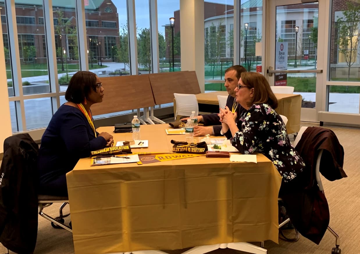 education faculty speaking together around a table