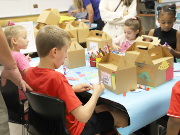 LRC-South family participants explore lunchbox activities at If You Take A Mouse to the LRC-South. 