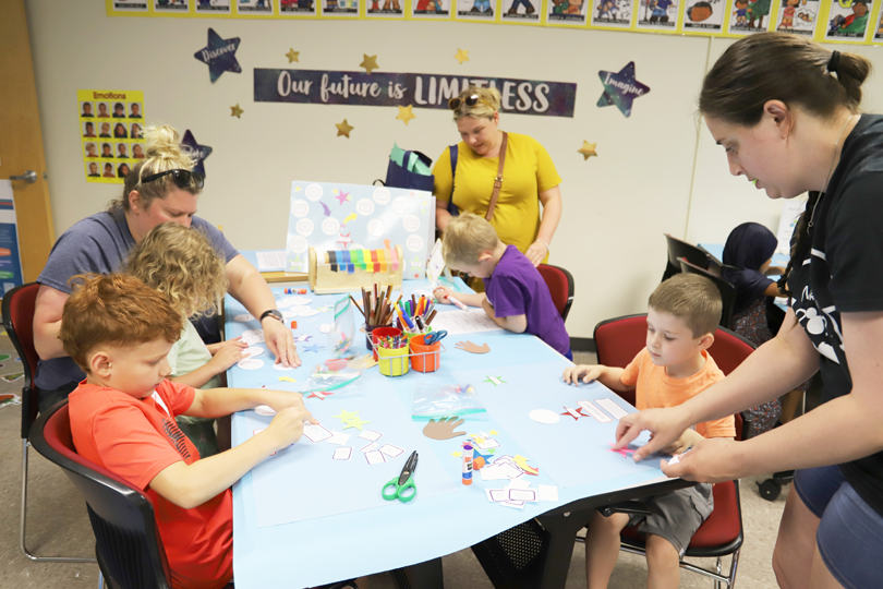 LRC-South family participants use hands-on materials at a center activity table during the 2024 Summer Family Series. 